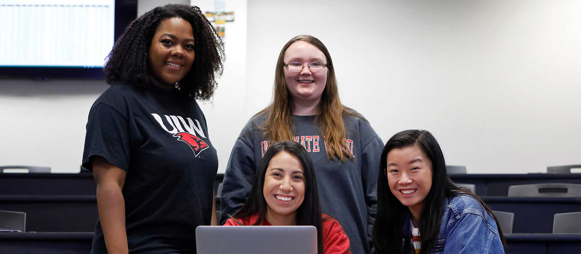 Three UIW students posing together in the Student Engagement Center building
