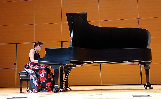 Nicole Pfaff playing the piano at her senior recital