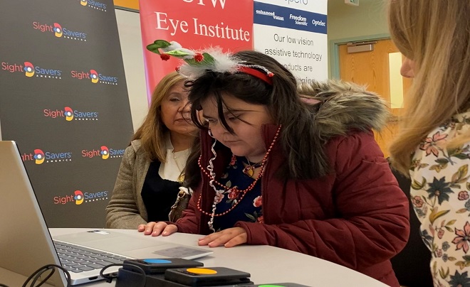 Young girl learning how to use vision equipment.