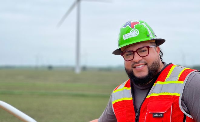 Josh Rangel in front of a windmill