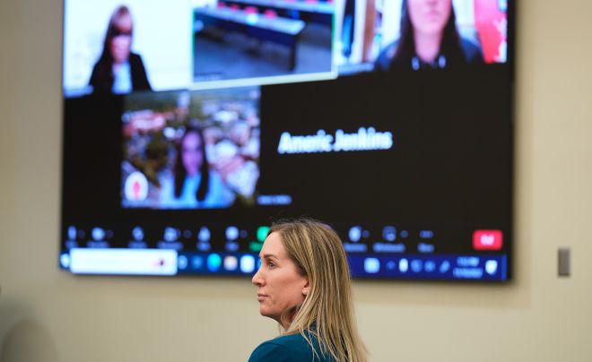 Woman speaking in front of a Zoom meeting
