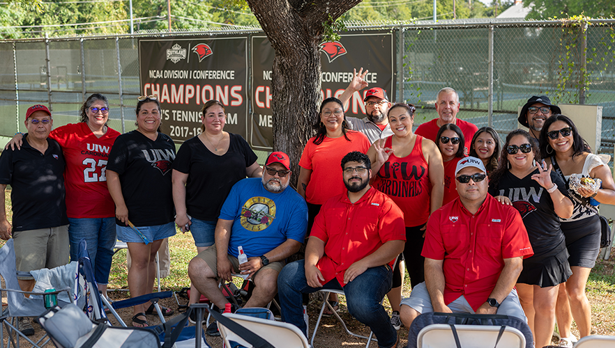 Cardinal families seated at UIW tailgate