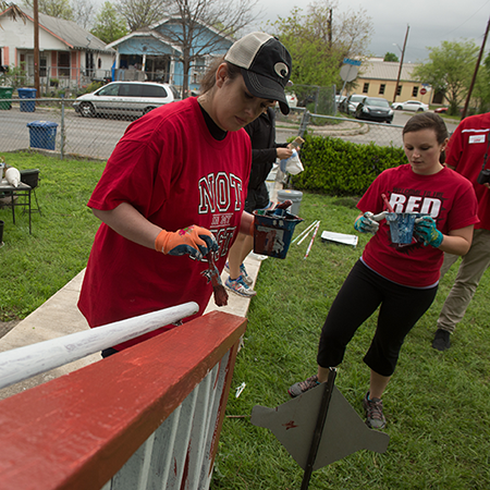 Students volunteering to paint a house