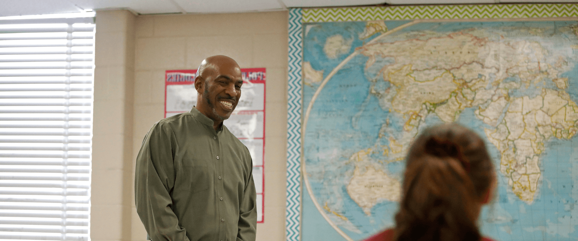 UIW Student Teacher in a classroom with elementary students raising their hand