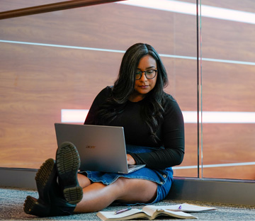 Photo of a Student working on a Laptop