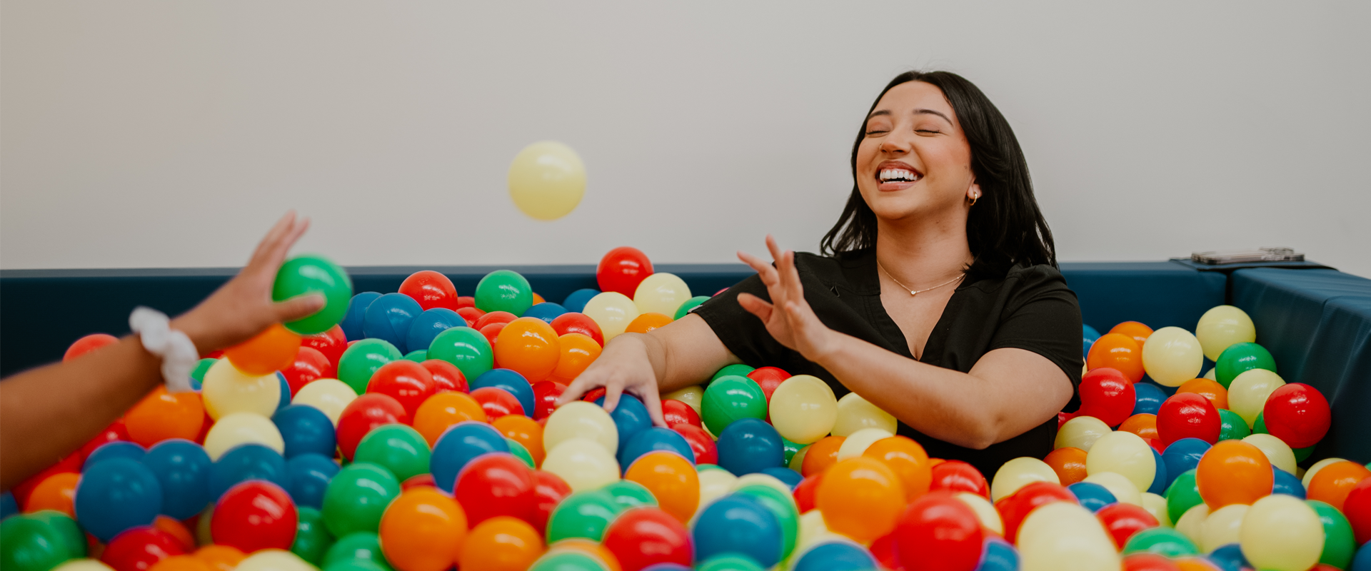 Occupational therapy student in a ball pit