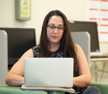 Adult student studying online on their laptop.