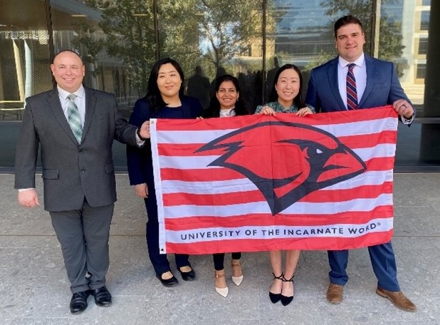 MHA Students at ACHE Student Symposium with UIW Flag