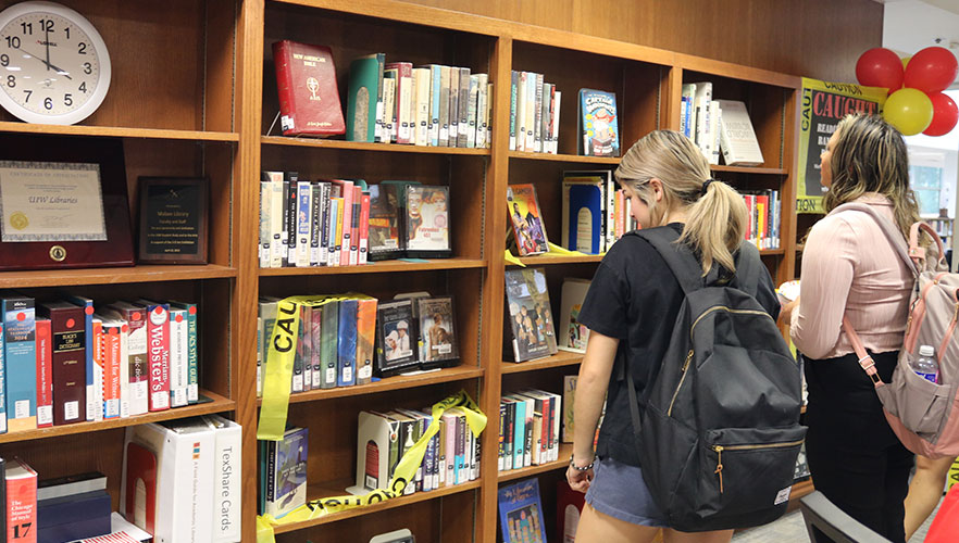 Attendees looking at banned books display