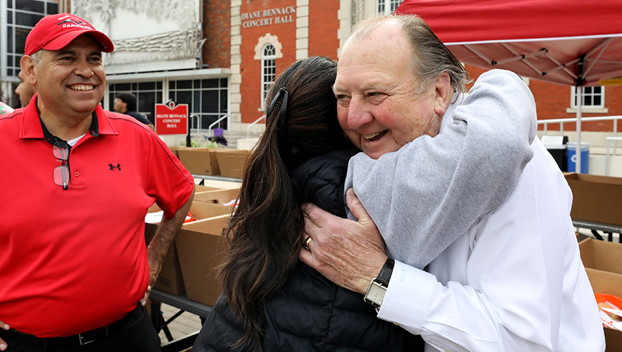 Volunteer hugging person