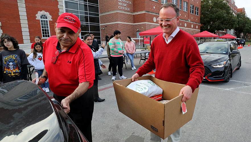 Dr. Evans and Dr. Gonzales distributing boxes