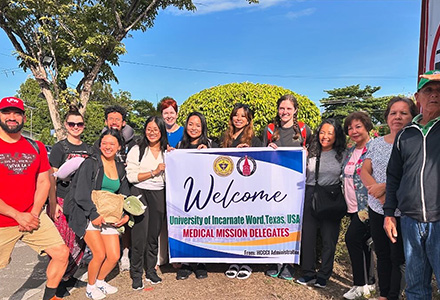 Group with welcome sign