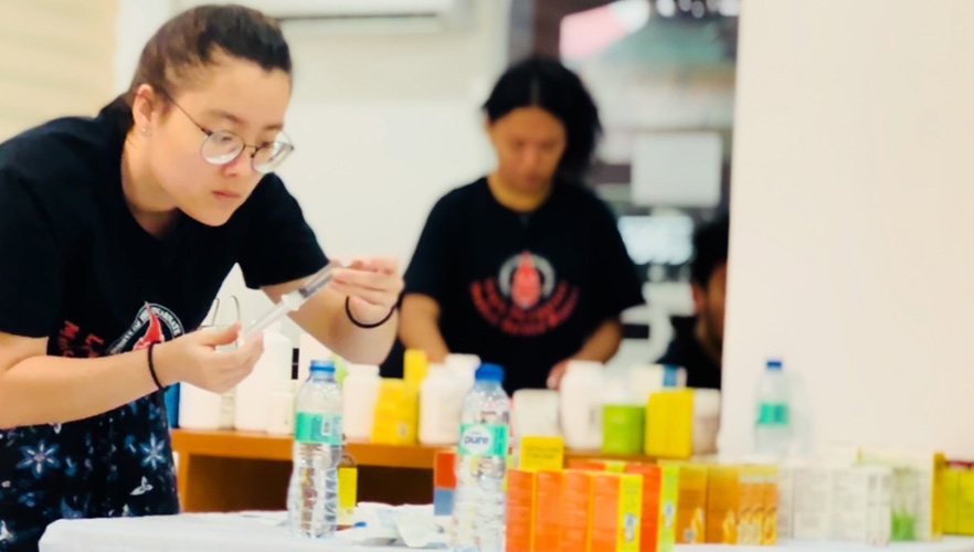 Student holding a syringe