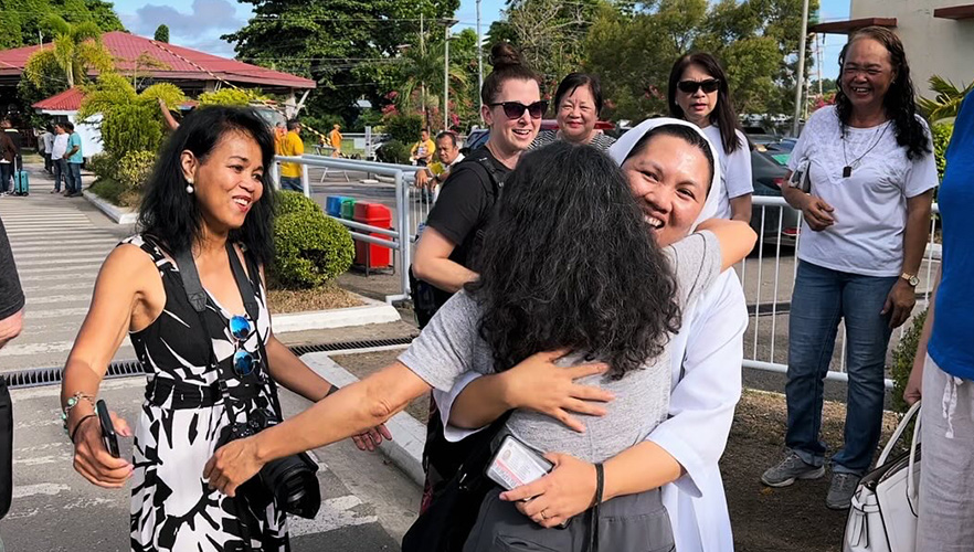 Sister with students and community members