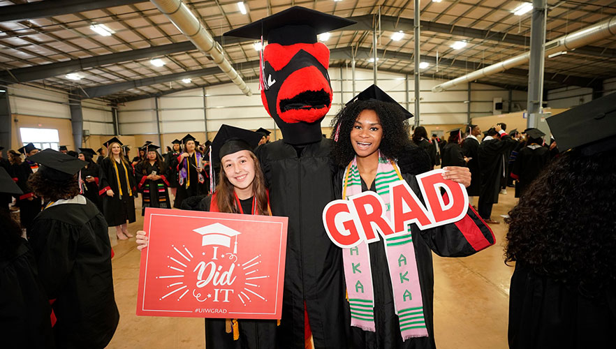 Spring 2024 graduates with Red the Cardinal