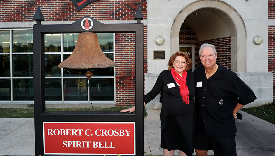 Kate Crosby and Rick Smith next to bell