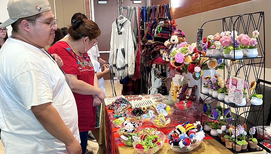 Attendees shopping at vendor table