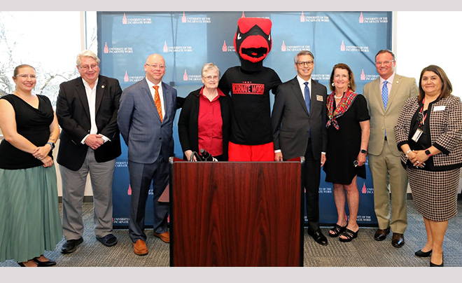 Red posing with UIW representatives