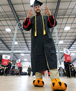 Denning wearing Red's feet at graduation