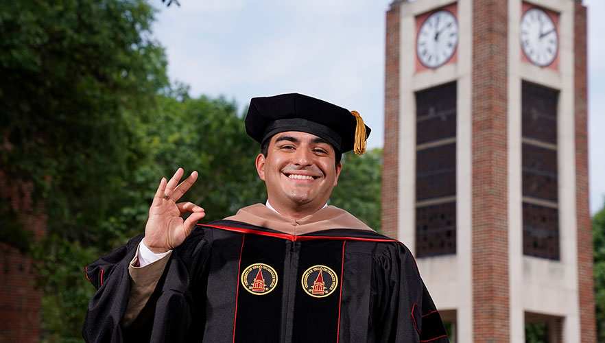 Grad in front of Clock Tower