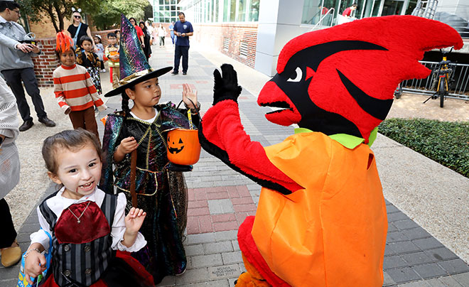 Red the Cardinal with treat-or-treater