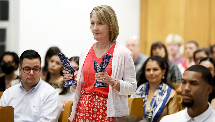 UIW school representative carrying symbolic object