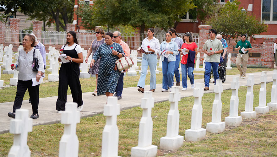 Attendees walking in CCVI cemetery