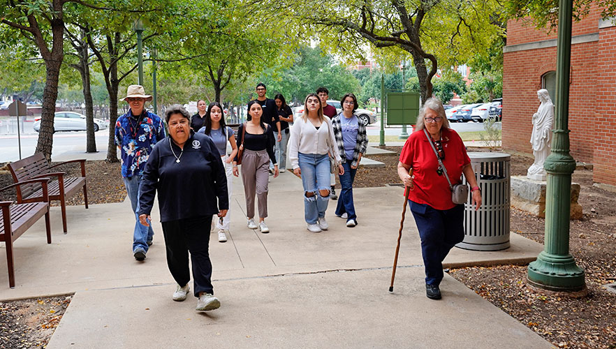 Tour group walking across campus