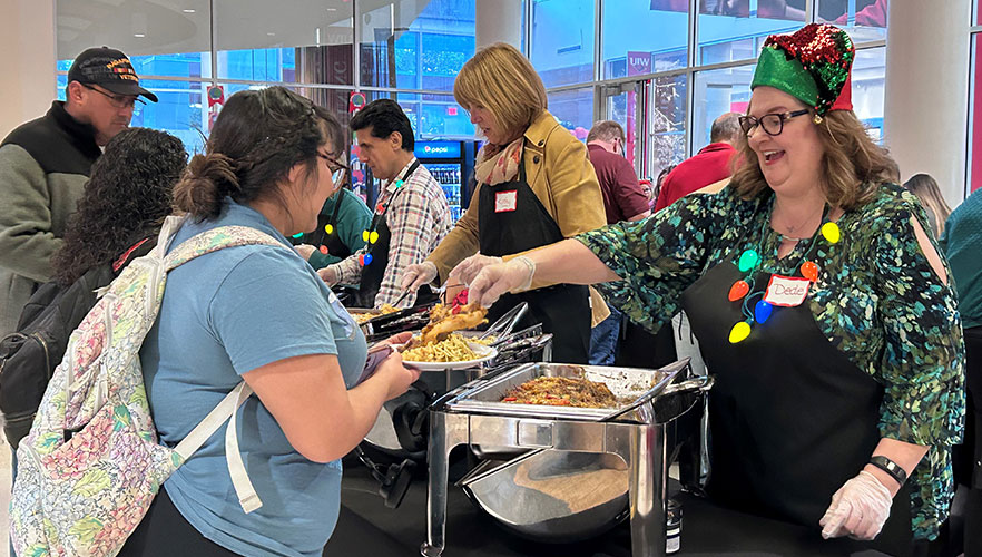 Students being served food by staff