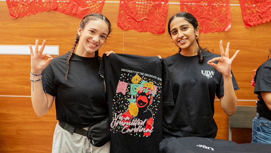 student posing with shirts