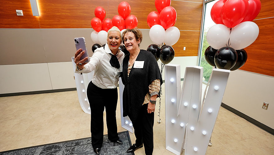 Reunion honorees smiling with UIW letters