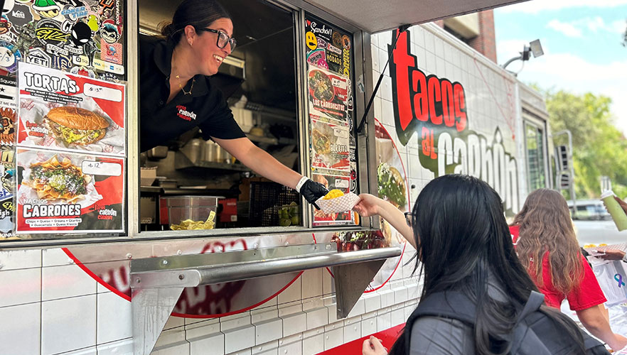 Student getting tacos and food truck