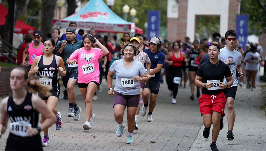 Runners running across campus