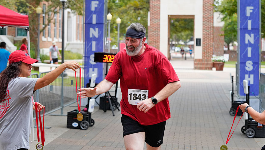 Runner being given medal at finish line