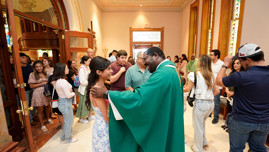 chaplain and student before mass