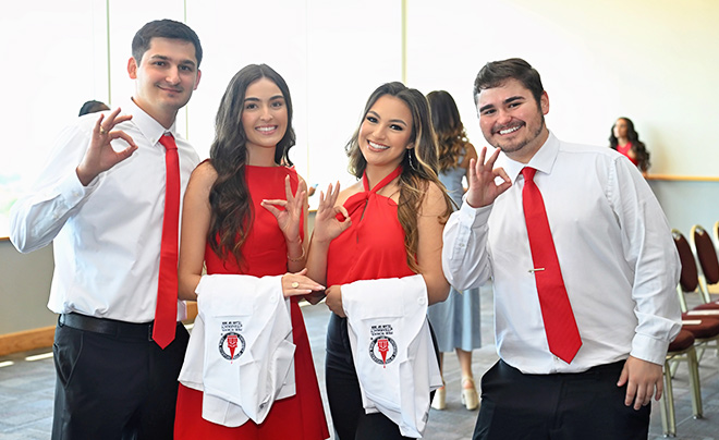 four students at whit coat ceremony