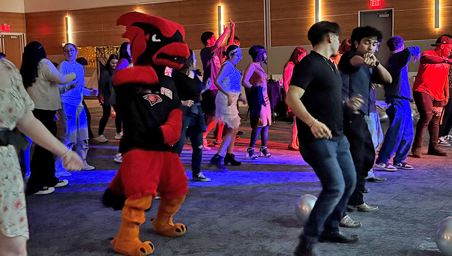 Red the Cardinal dancing with students