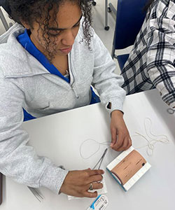 Student practicing suture skills