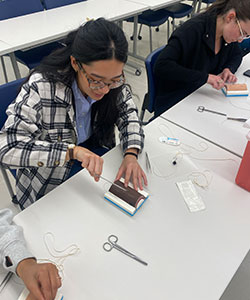 Student practicing suture skills