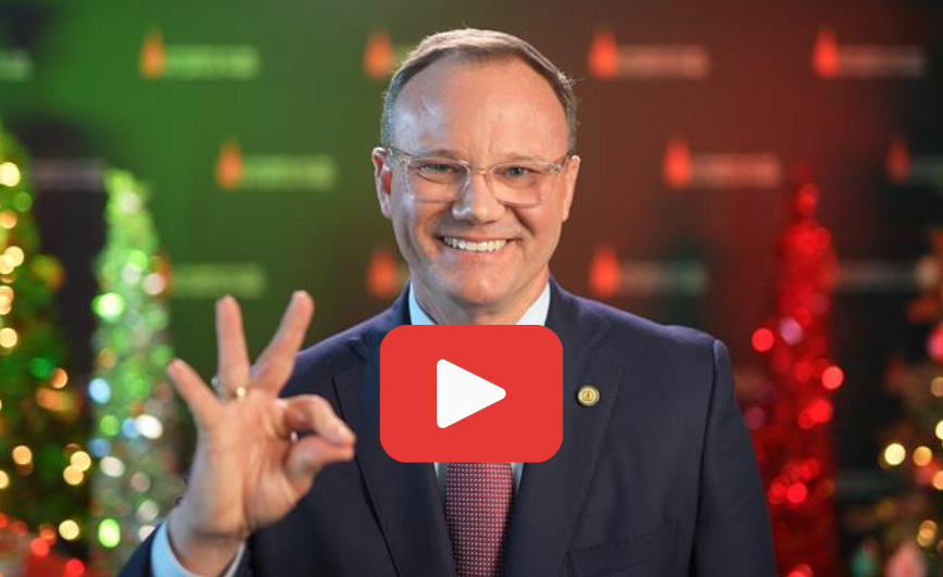 UIW President Evans against Christmas backdrop