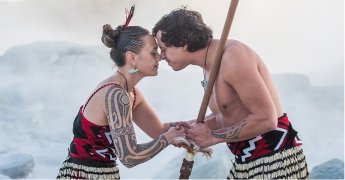 two people greeting one another with forehead and noses touching