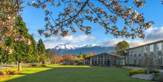 Accommodations: a sunny day-- the hotel is covered in windows and nestled picturesquely in front of ice-capped mountains